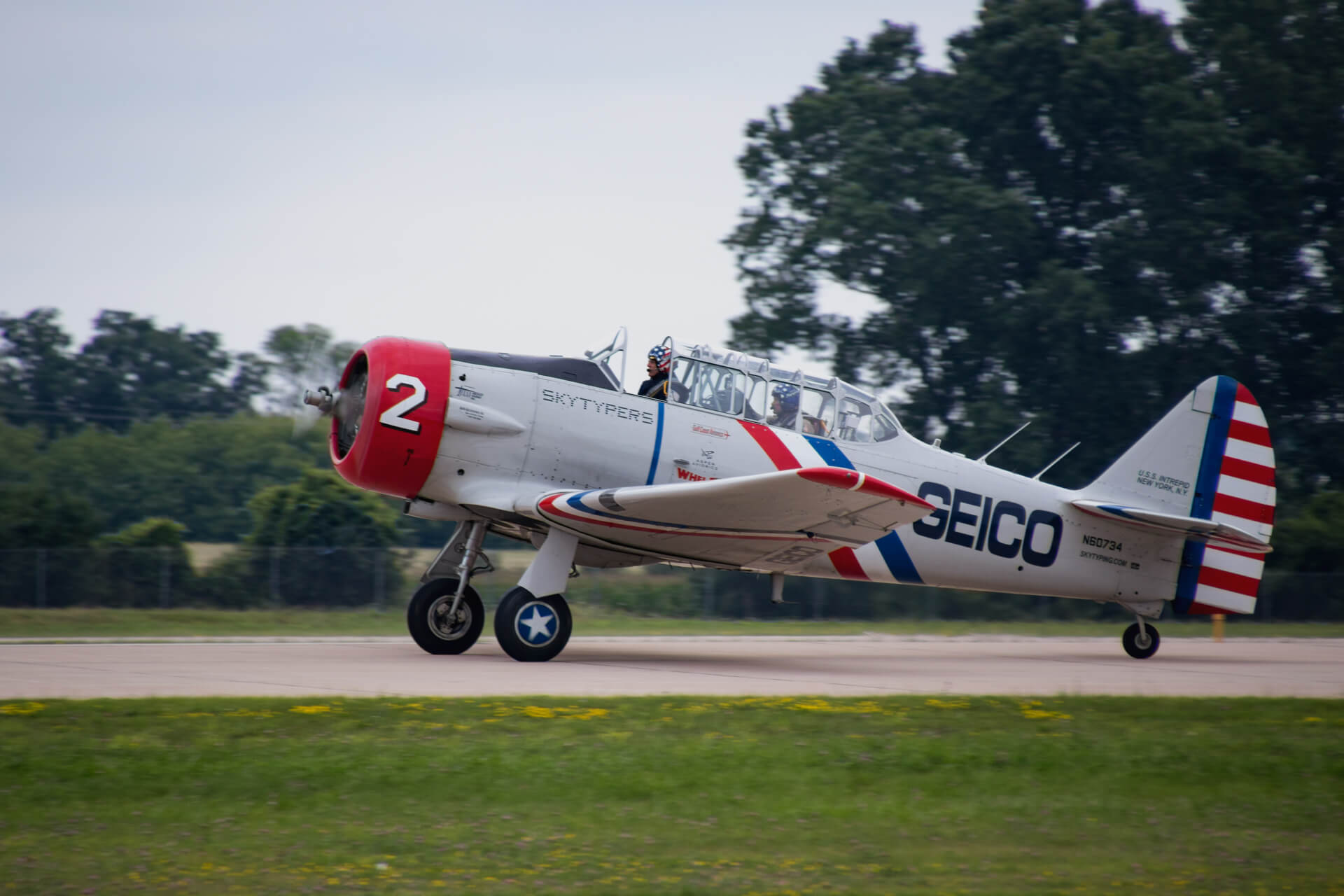 One of the Geico Skytypers do a drive by after landing their T-6 Texan SNJ-2.