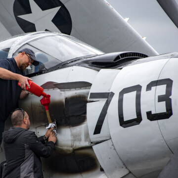 Topping off the oil of a Douglas EA-1E Skyraider.